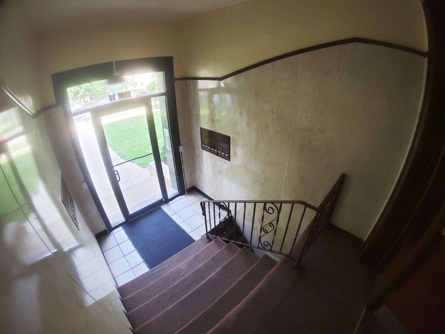 6527 South Kimbark Avenue, Unit 1F Chicago, IL 60637 - Photo 4 of 18 a view of a hallway with wooden floor and stairs