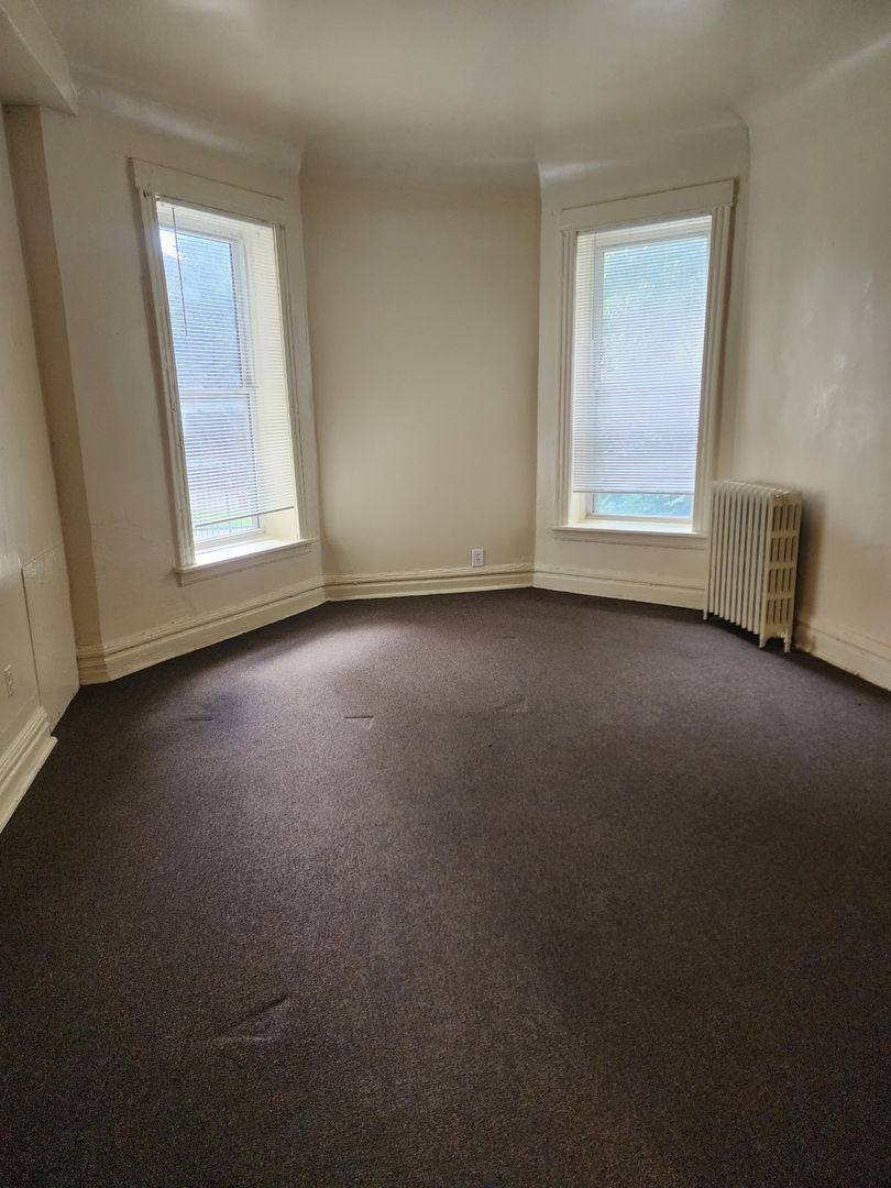 6527 South Kimbark Avenue, Unit 1F Chicago, IL 60637 - Photo 8 of 18 a view of empty room with window
