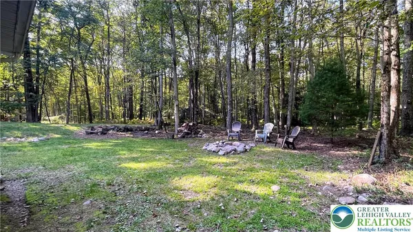 a view of a backyard with sitting area