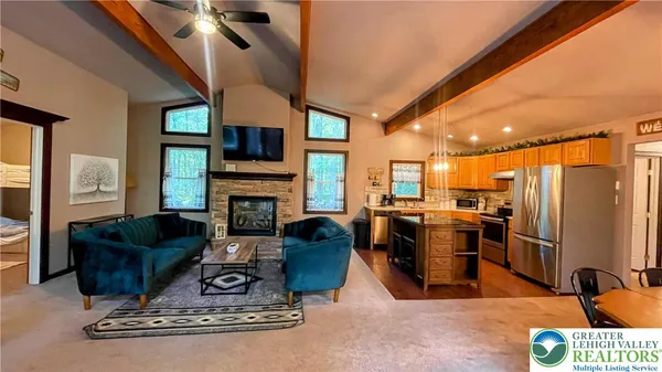 a living room with furniture a flat screen tv and a fireplace