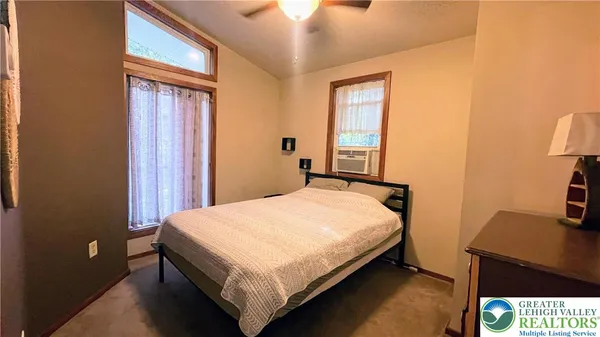 a bed sitting in a bedroom next to a window