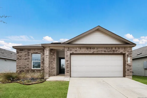 a front view of a house with a garden and garage