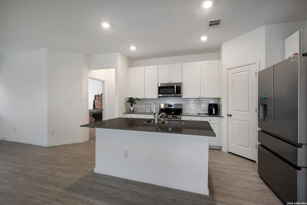 a kitchen with stainless steel appliances a refrigerator stove microwave and sink