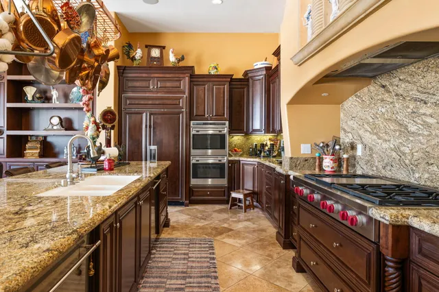 a living room with furniture a fireplace and a large window