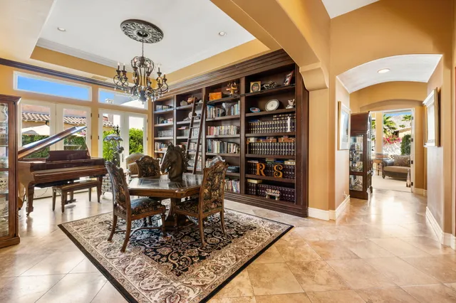 a view of a dining room with furniture a chandelier and wooden floor