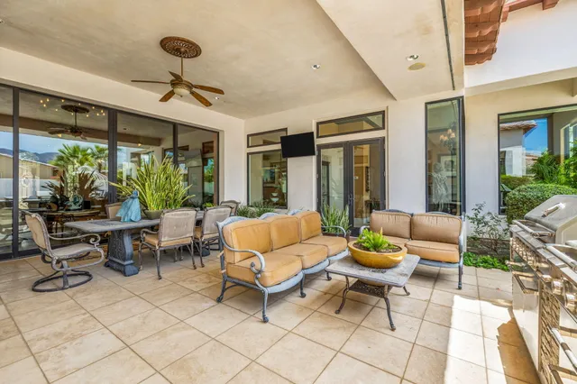 a living room with furniture a rug and a large window