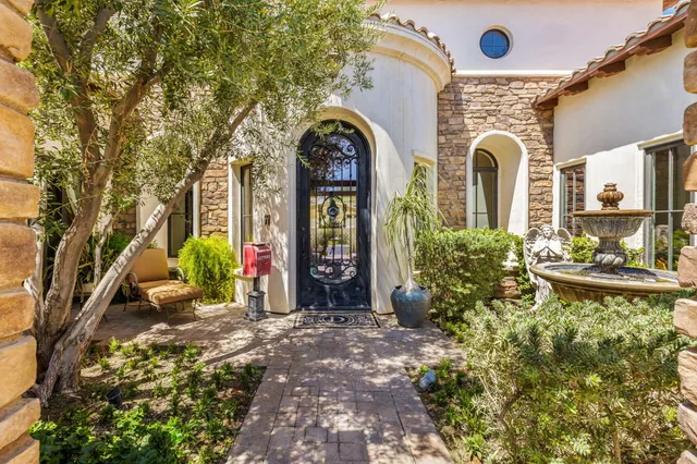 a living room with furniture a rug and a book shelf