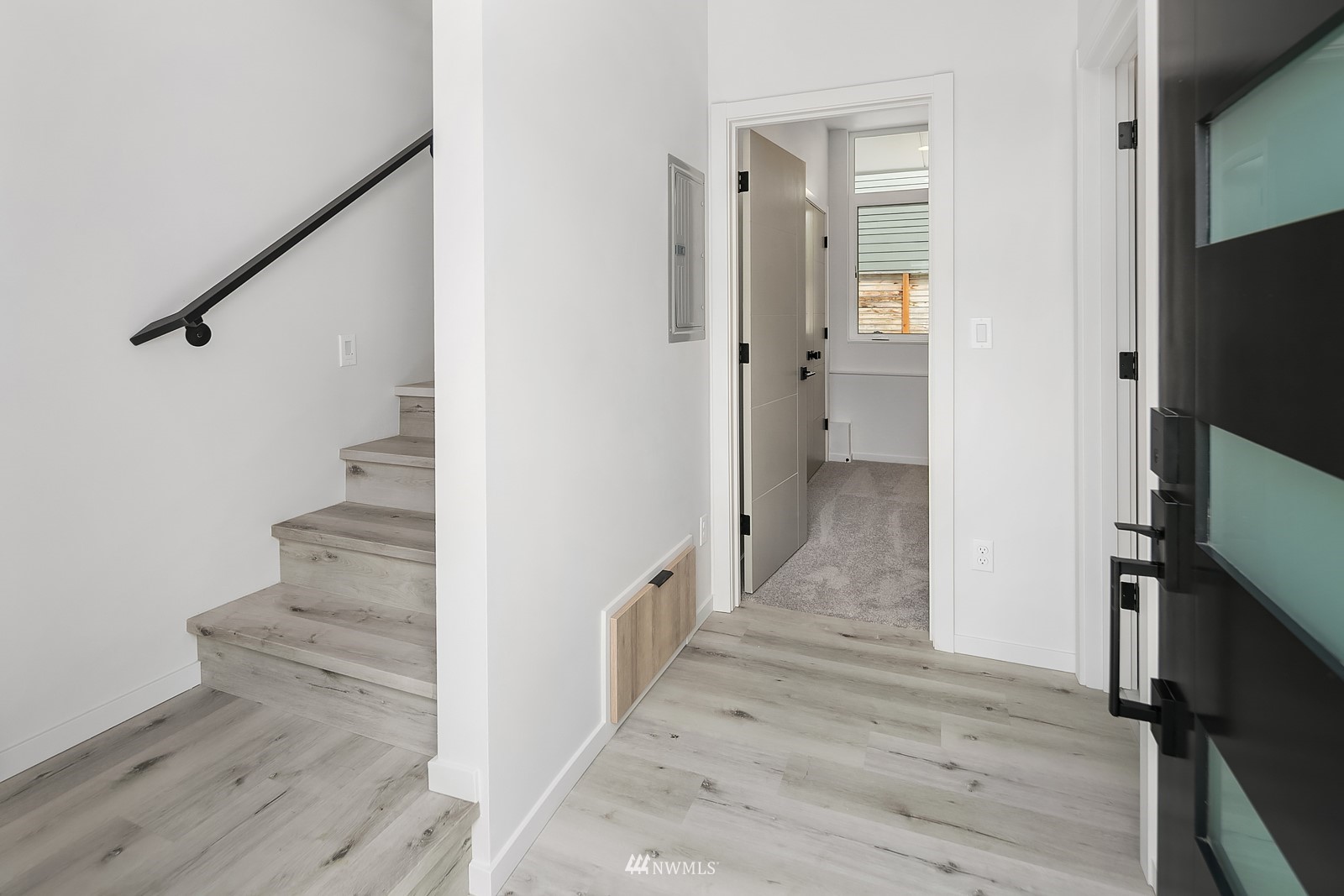 604 North 43rd Street Seattle, WA 98103 - Photo 6 of 26 a view of a hallway with wooden floor and staircase