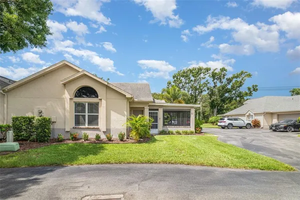 a front view of house with yard and green space