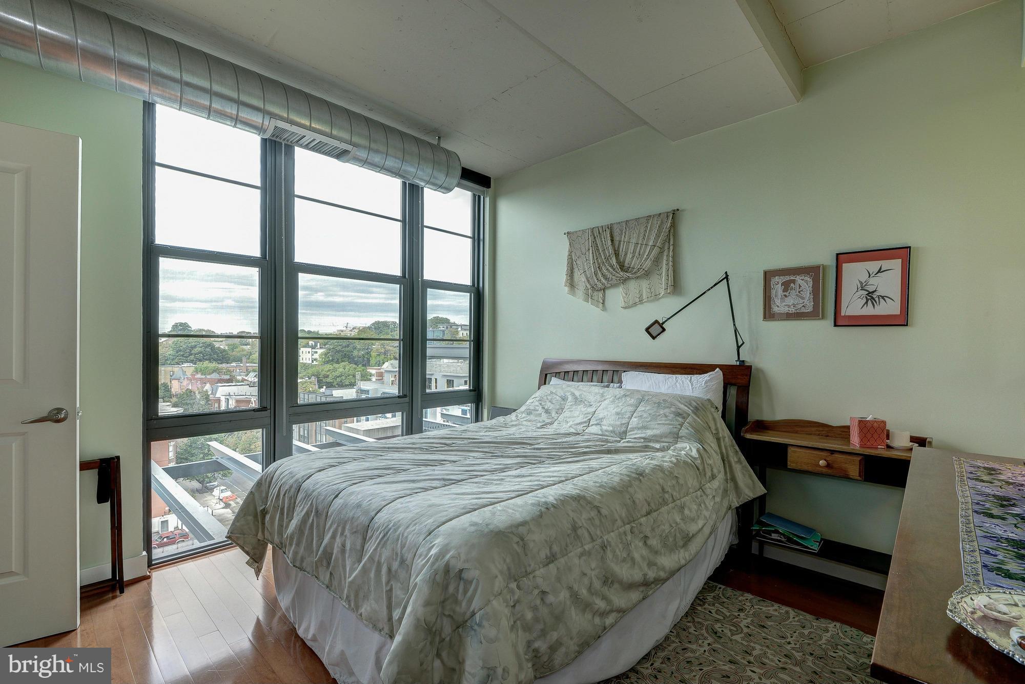 2125 14th Street Northwest, Unit 913 Washington, DC 20009 - Photo 5 of 14 a bedroom with a bed and a window