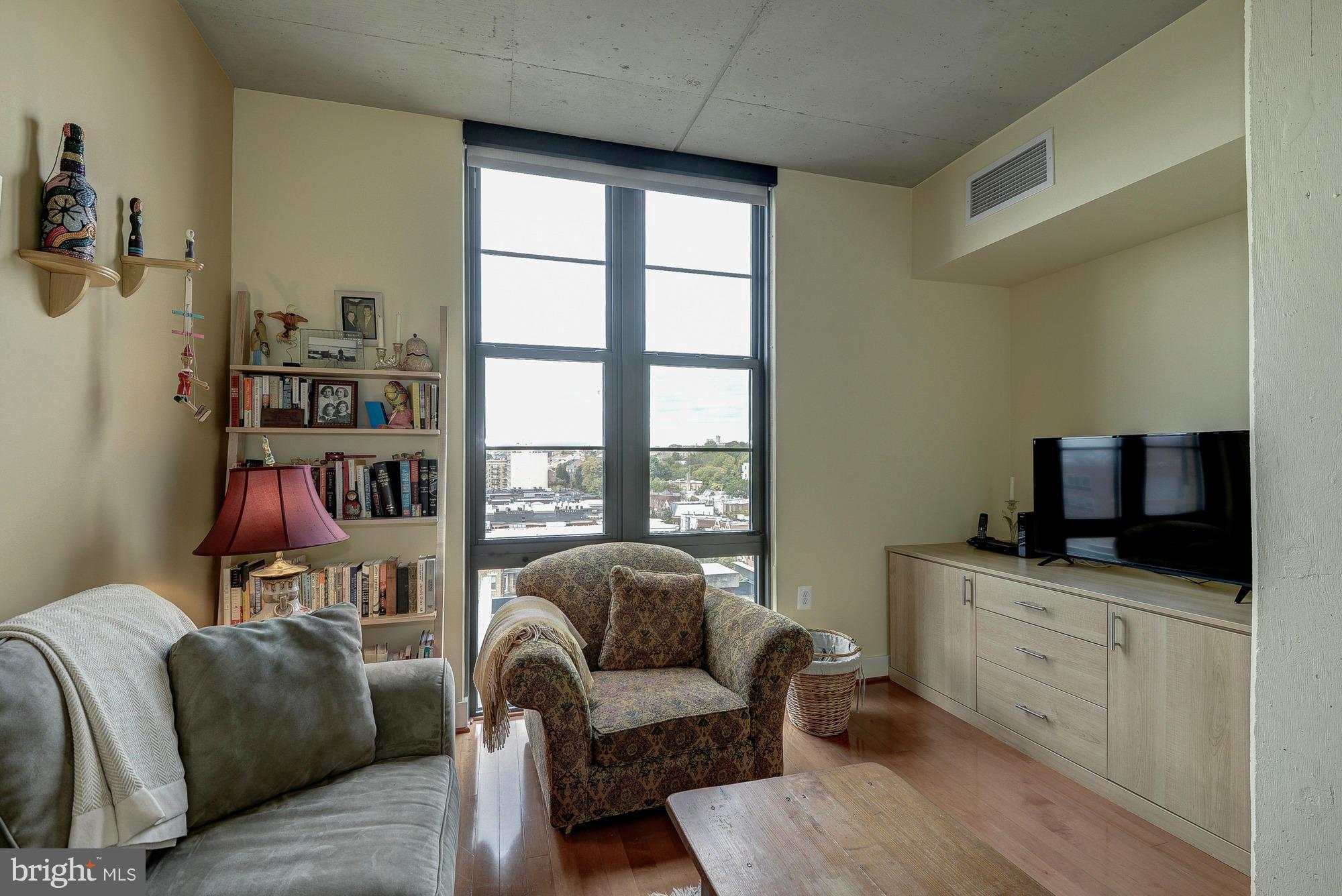 2125 14th Street Northwest, Unit 913 Washington, DC 20009 - Photo 7 of 14 a living room with furniture and a flat screen tv