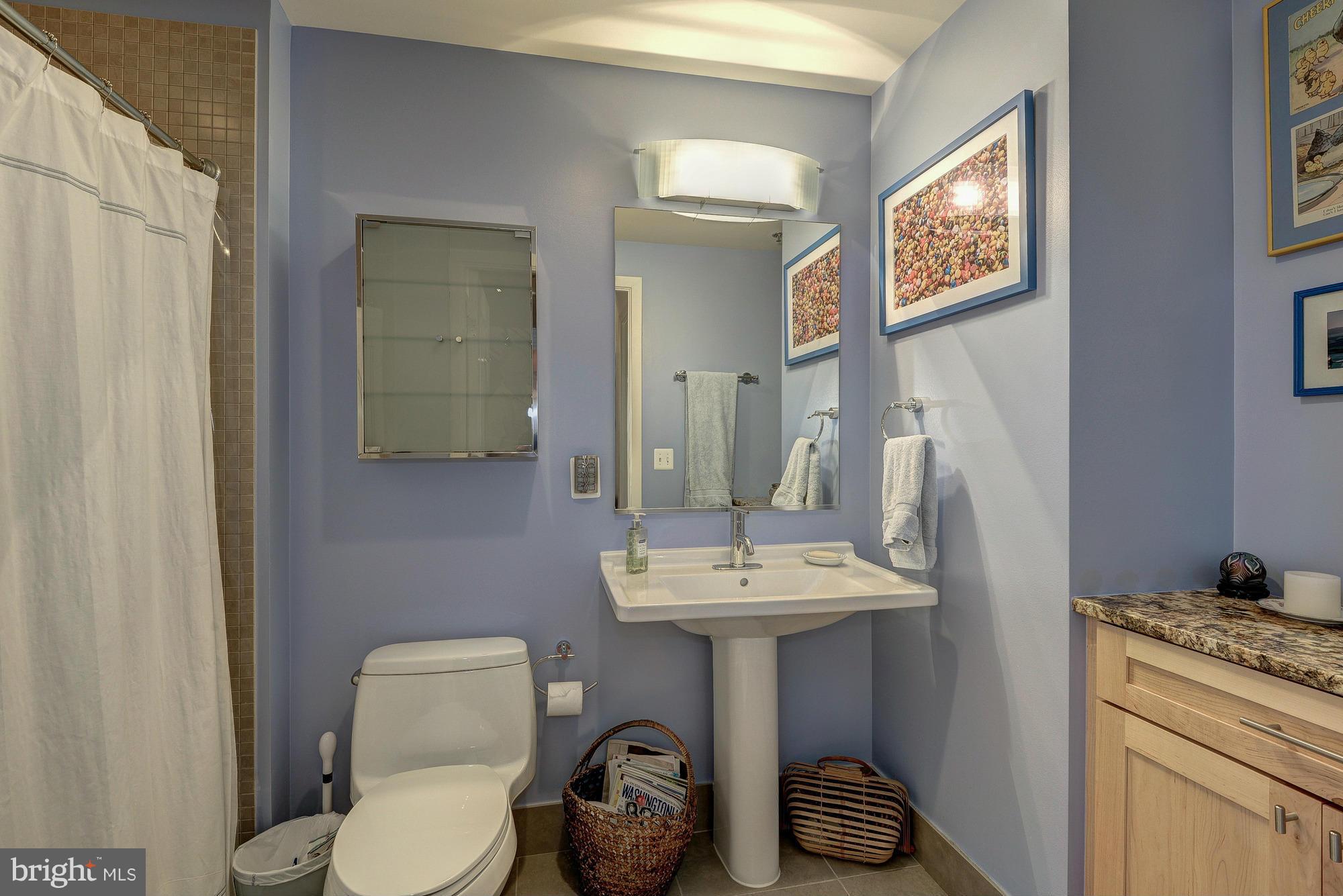 2125 14th Street Northwest, Unit 913 Washington, DC 20009 - Photo 8 of 14 a bathroom with a sink toilet and a mirror