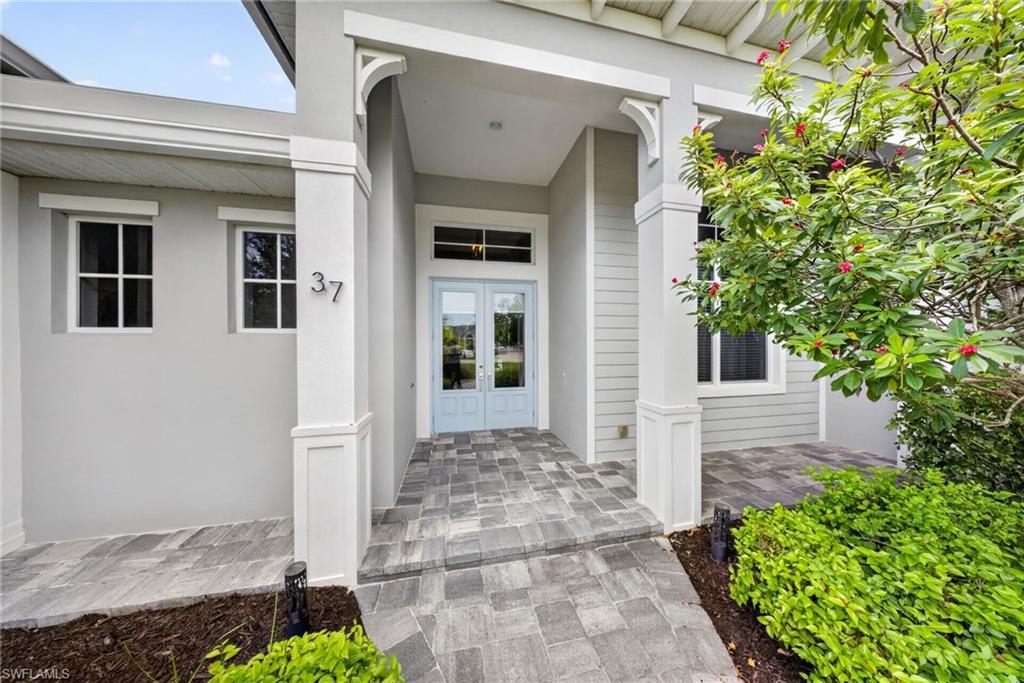 37 Johnnycake Drive Naples, FL 34110 - Photo 31 of 33 Aerial perspective showcasing a single-story residence with a dark shingle roof