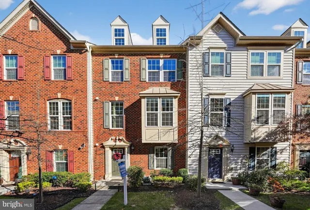 a front view of a residential apartment building with a yard