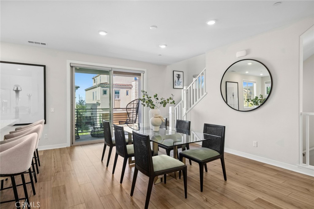 526 Serrano Summit Drive Lake Forest, CA 92630 - Photo 11 of 59 a view of a dining room with furniture a potted plant and wooden floor
