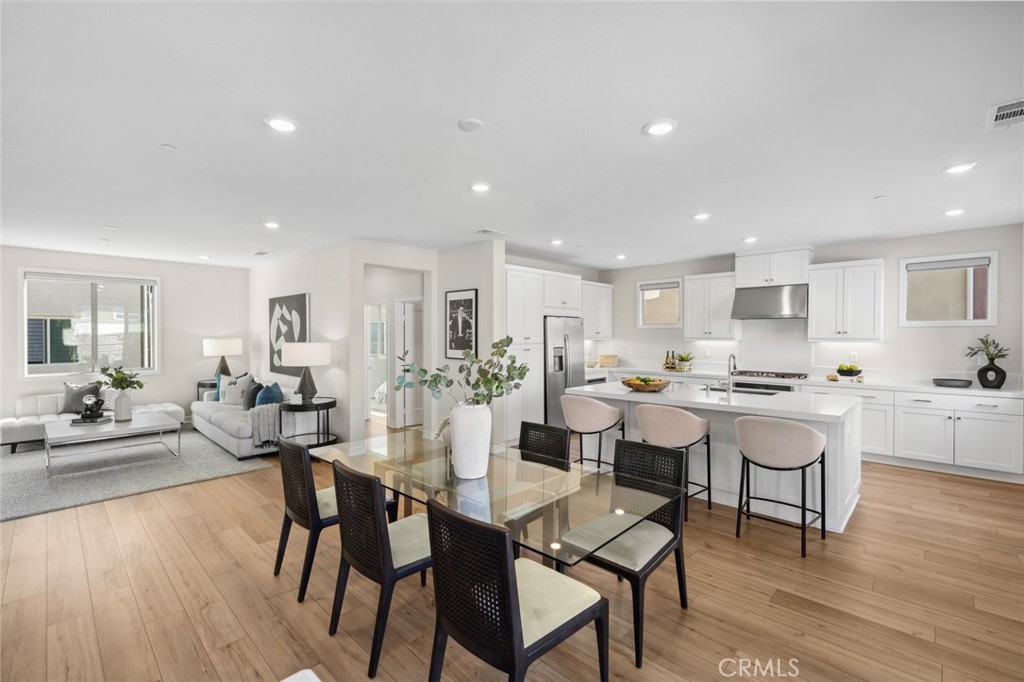 526 Serrano Summit Drive Lake Forest, CA 92630 - Photo 13 of 59 a view of a dining room with furniture and wooden floor