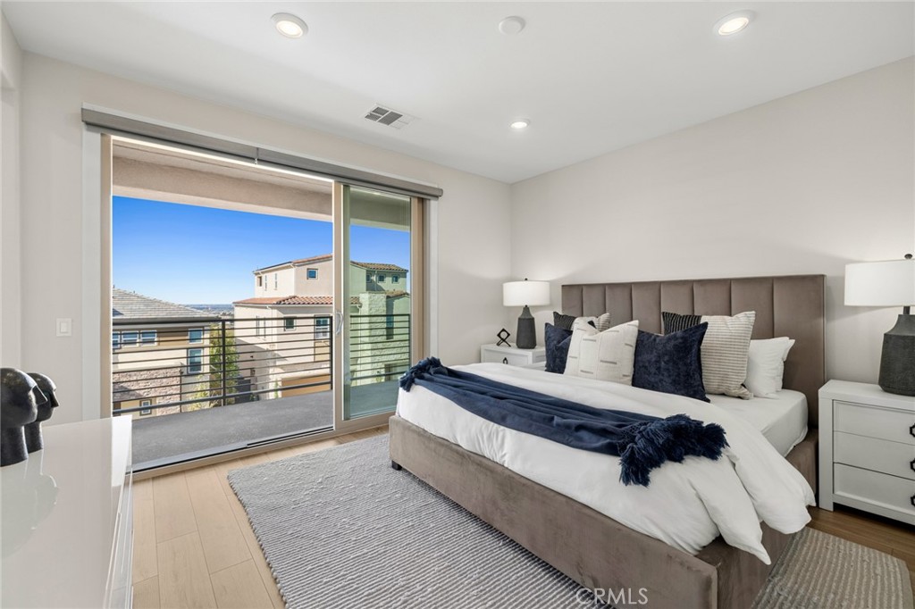 526 Serrano Summit Drive Lake Forest, CA 92630 - Photo 18 of 59 a spacious bedroom with a bed and a large window
