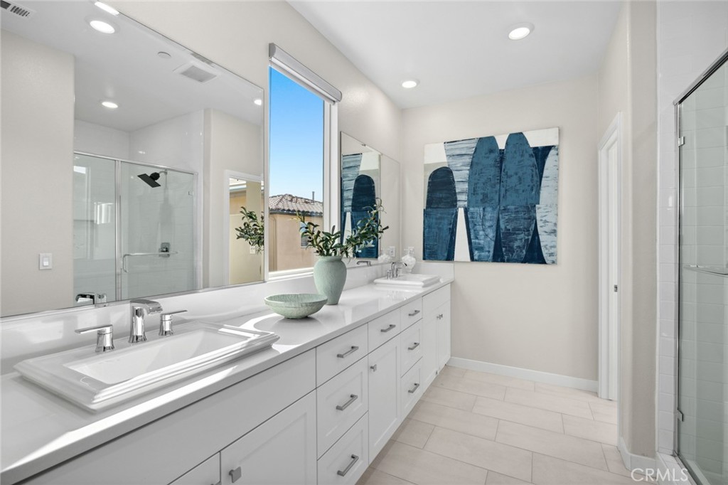 526 Serrano Summit Drive Lake Forest, CA 92630 - Photo 25 of 59 a bathroom with double vanity sinks and a large mirror