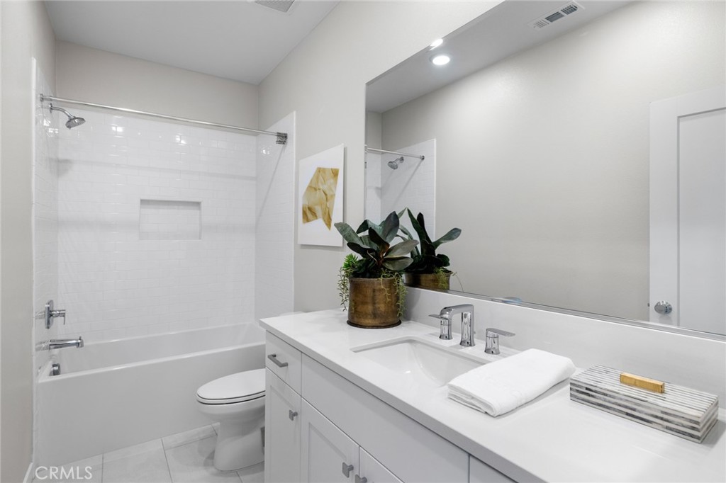526 Serrano Summit Drive Lake Forest, CA 92630 - Photo 27 of 59 a bathroom with a granite countertop sink a toilet and shower
