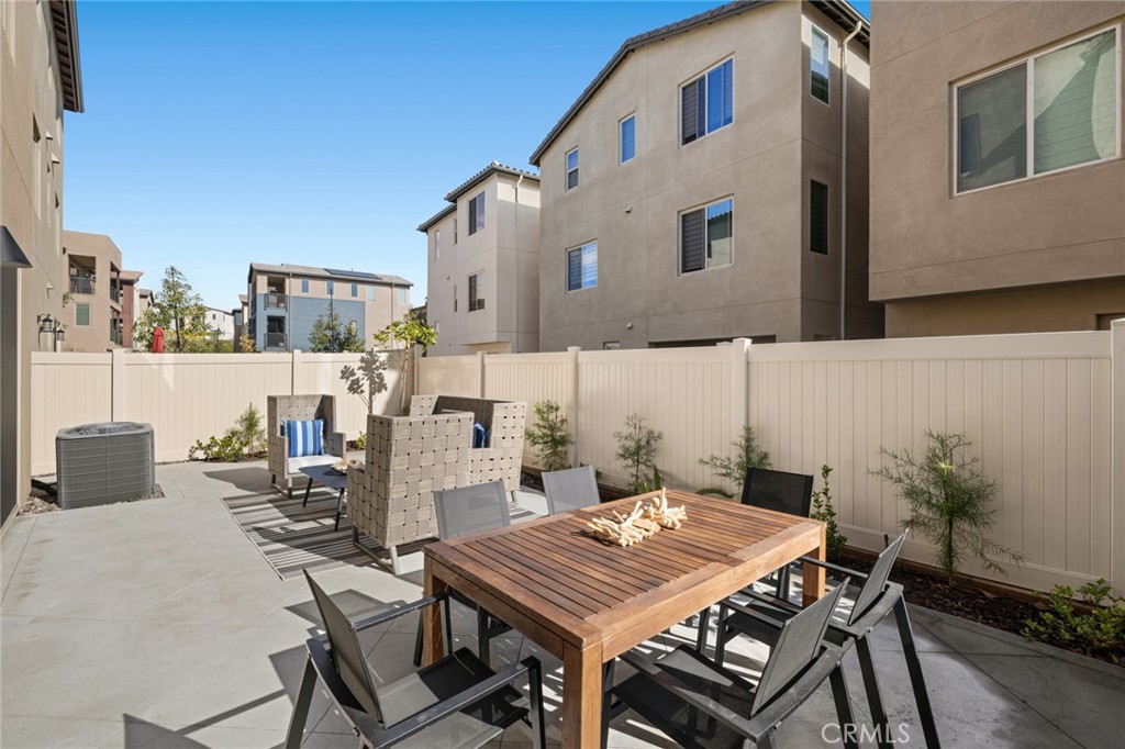 526 Serrano Summit Drive Lake Forest, CA 92630 - Photo 31 of 59 a view of a patio with table and chairs and potted plants