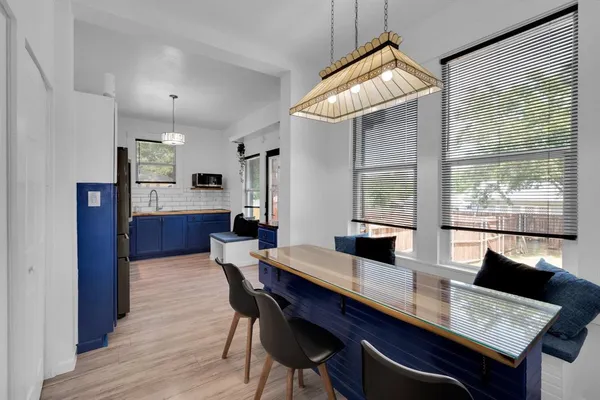 a dining room with furniture and wooden floor