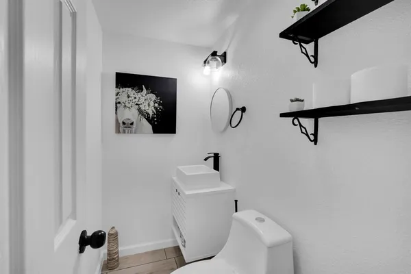 a bathroom with a sink mirror and toilet