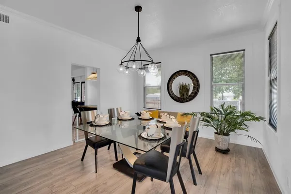 a dining room with furniture and wooden floor