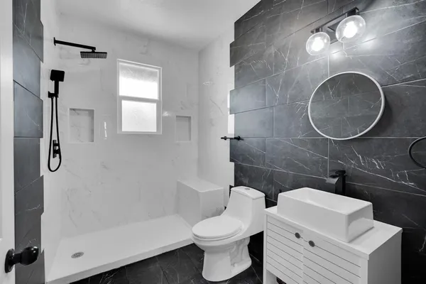 a bathroom with a toilet sink and shower