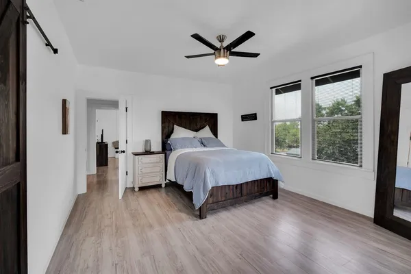 a bedroom with a bed and a large window