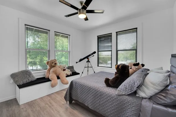 a bedroom with two beds and a large window