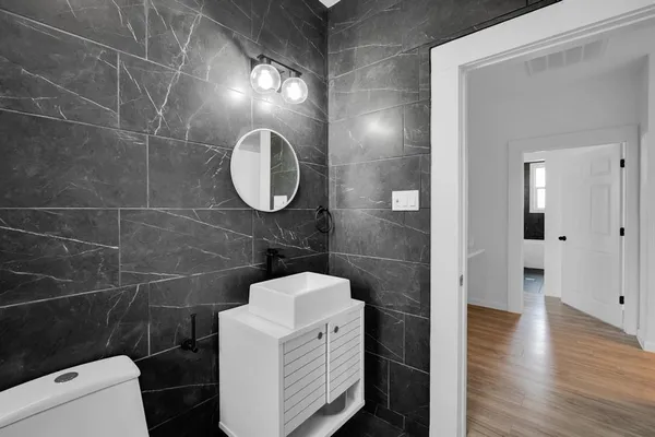 a bathroom with a toilet and a shower