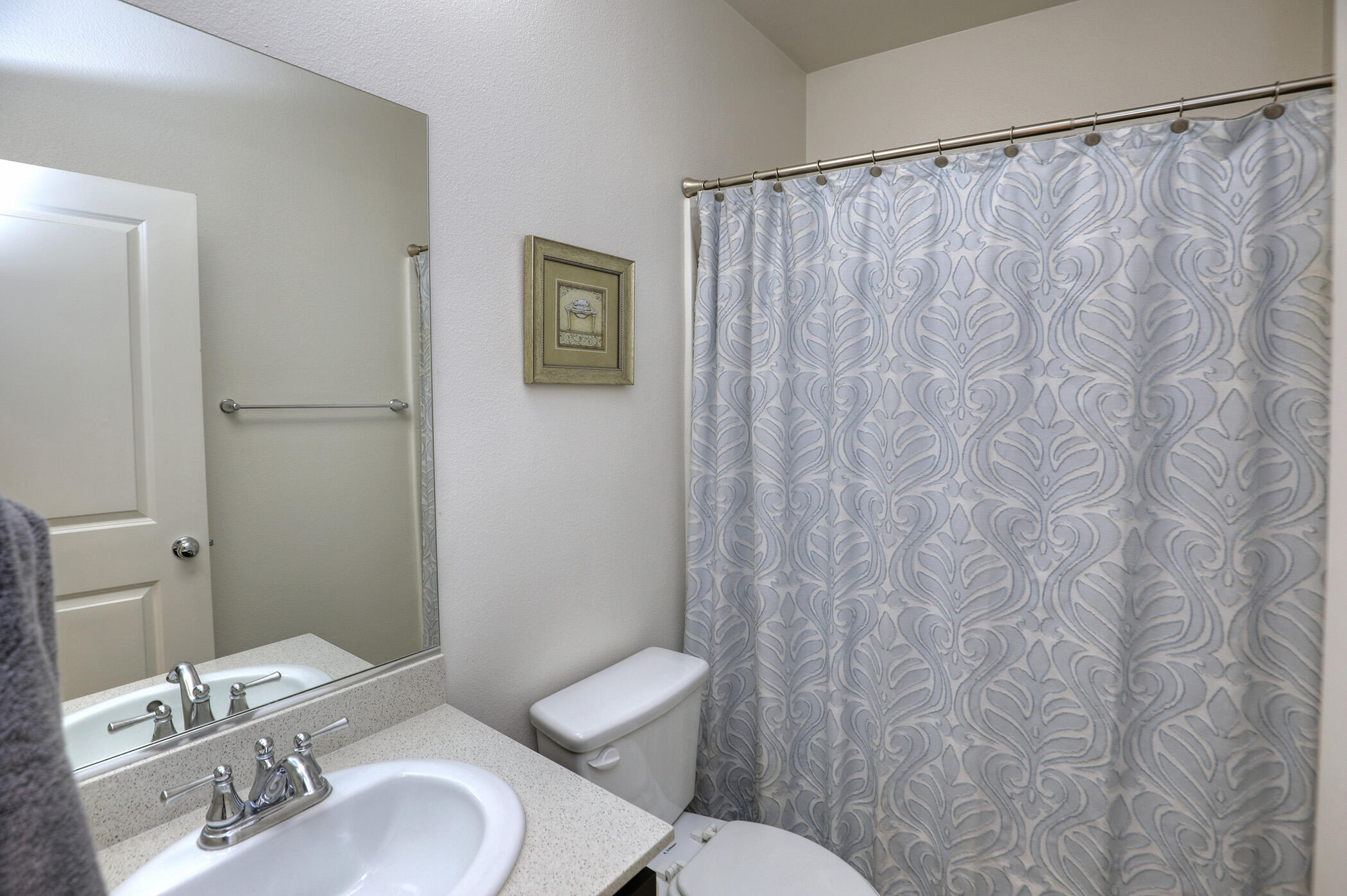 6607 Fathom Way Goleta, CA 93117 - Photo 17 of 37 a white toilet sitting next to a bathroom sink