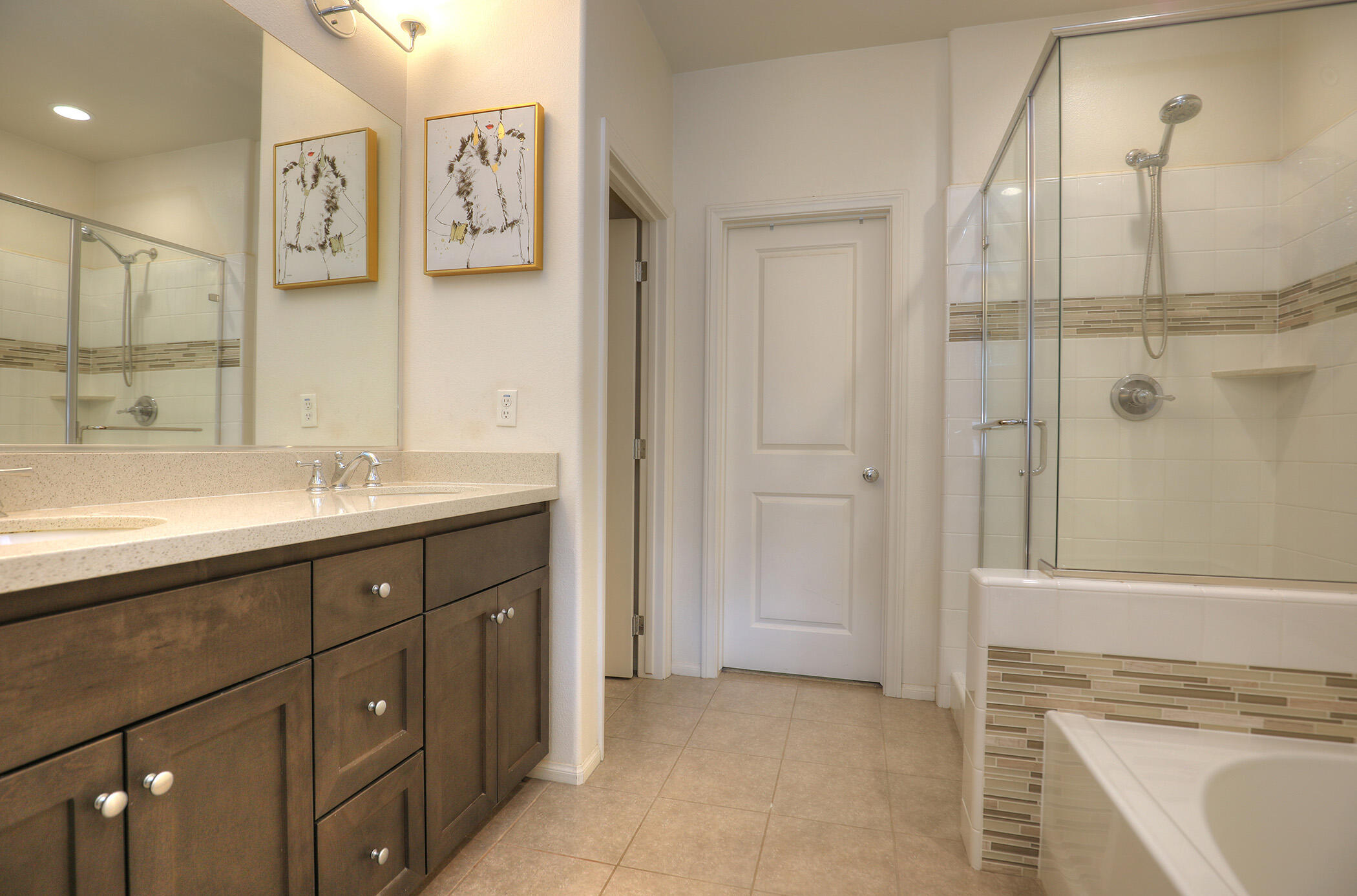 6607 Fathom Way Goleta, CA 93117 - Photo 20 of 37 a spacious bathroom with a double vanity sink a mirror and a shower