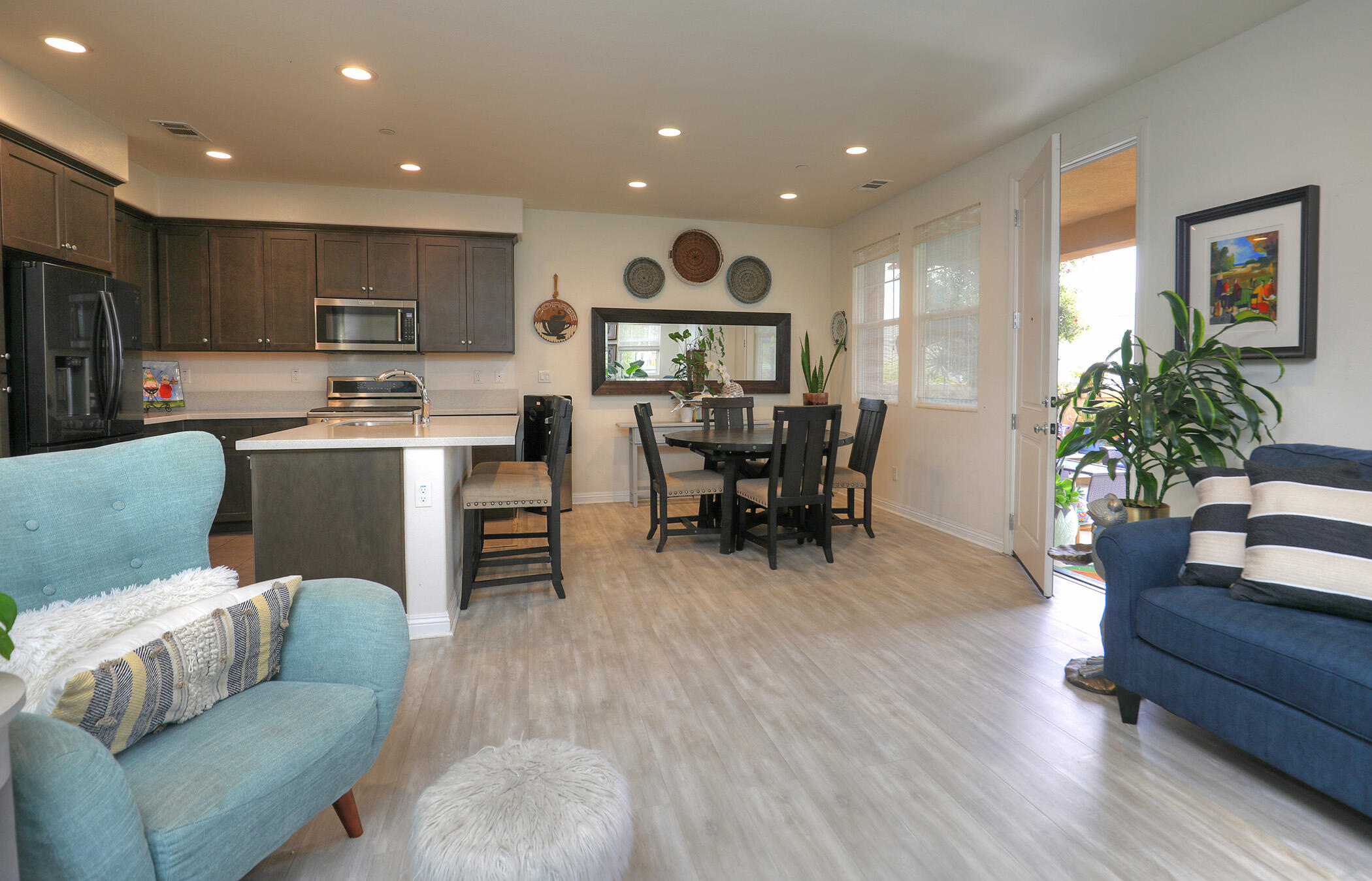 6607 Fathom Way Goleta, CA 93117 - Photo 9 of 37 a living room with furniture a dining table and kitchen view with wooden floor