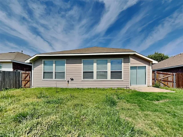 a house with lots of trees in the background