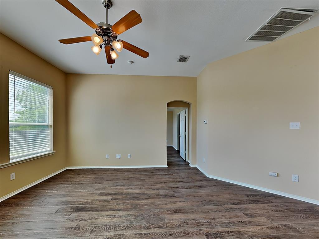 645 Chalk Knoll Road Fort Worth, TX 76108 - Photo 2 of 17 an empty room with wooden floor chandelier fan and windows