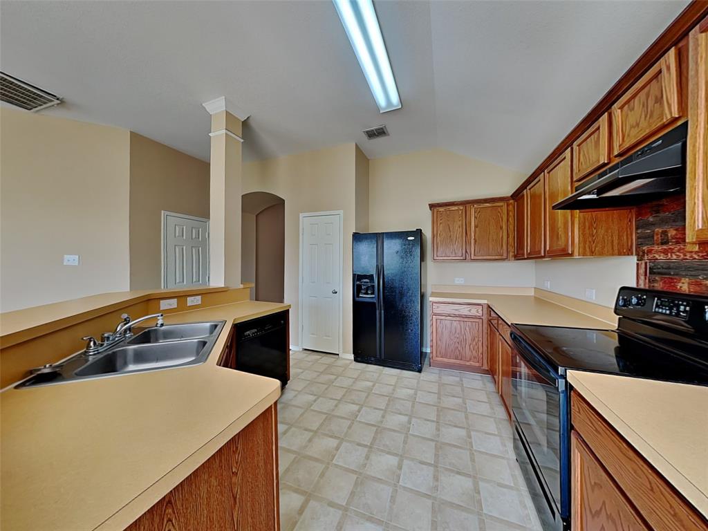645 Chalk Knoll Road Fort Worth, TX 76108 - Photo 4 of 17 a kitchen with a sink appliances and cabinets