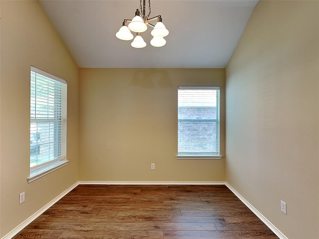 645 Chalk Knoll Road Fort Worth, TX 76108 - Photo 5 of 17 an empty room with wooden floor and windows