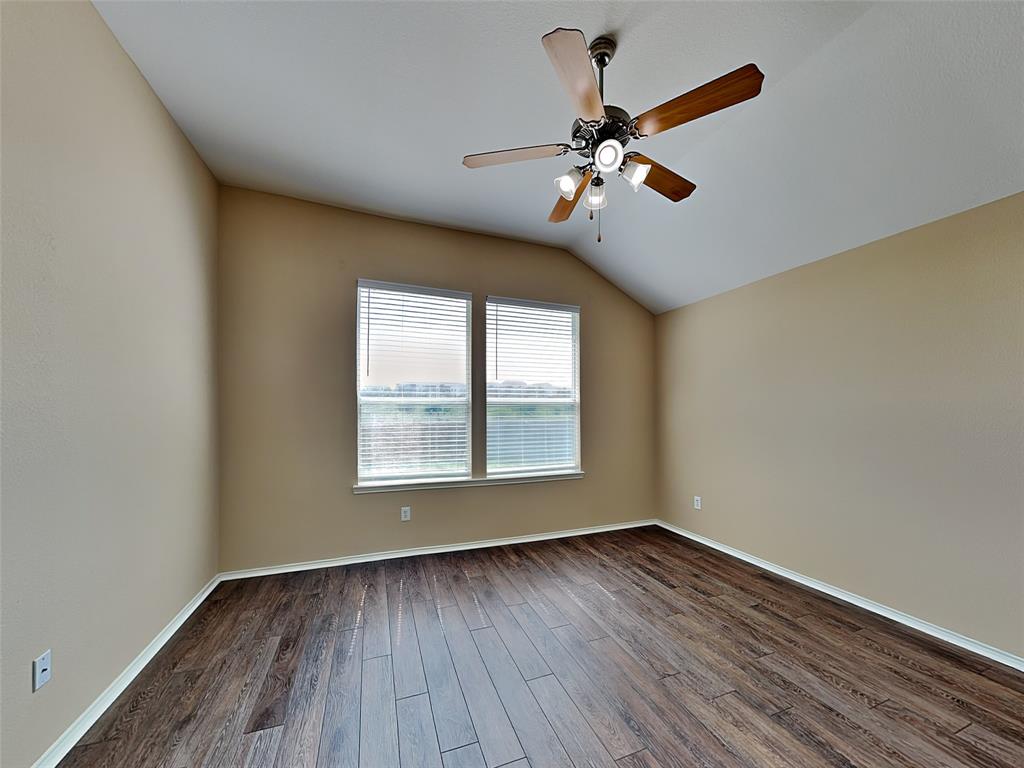 645 Chalk Knoll Road Fort Worth, TX 76108 - Photo 7 of 17 a view of an empty room with wooden floor and a window
