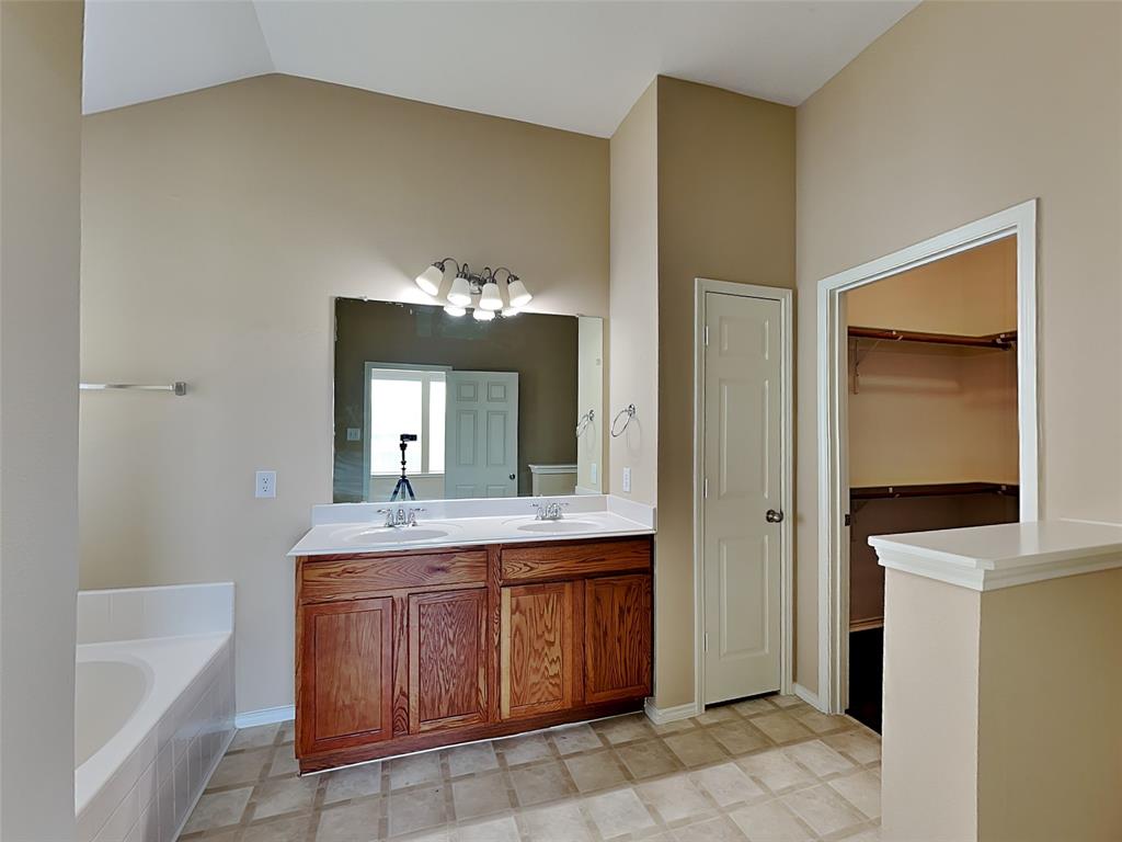 645 Chalk Knoll Road Fort Worth, TX 76108 - Photo 9 of 17 a en suite bathroom with a granite countertop sink and a mirror