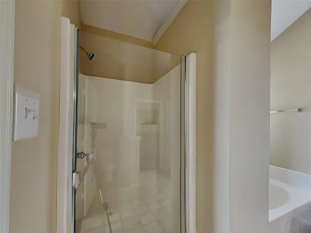 a bathroom with a shower and a glass door