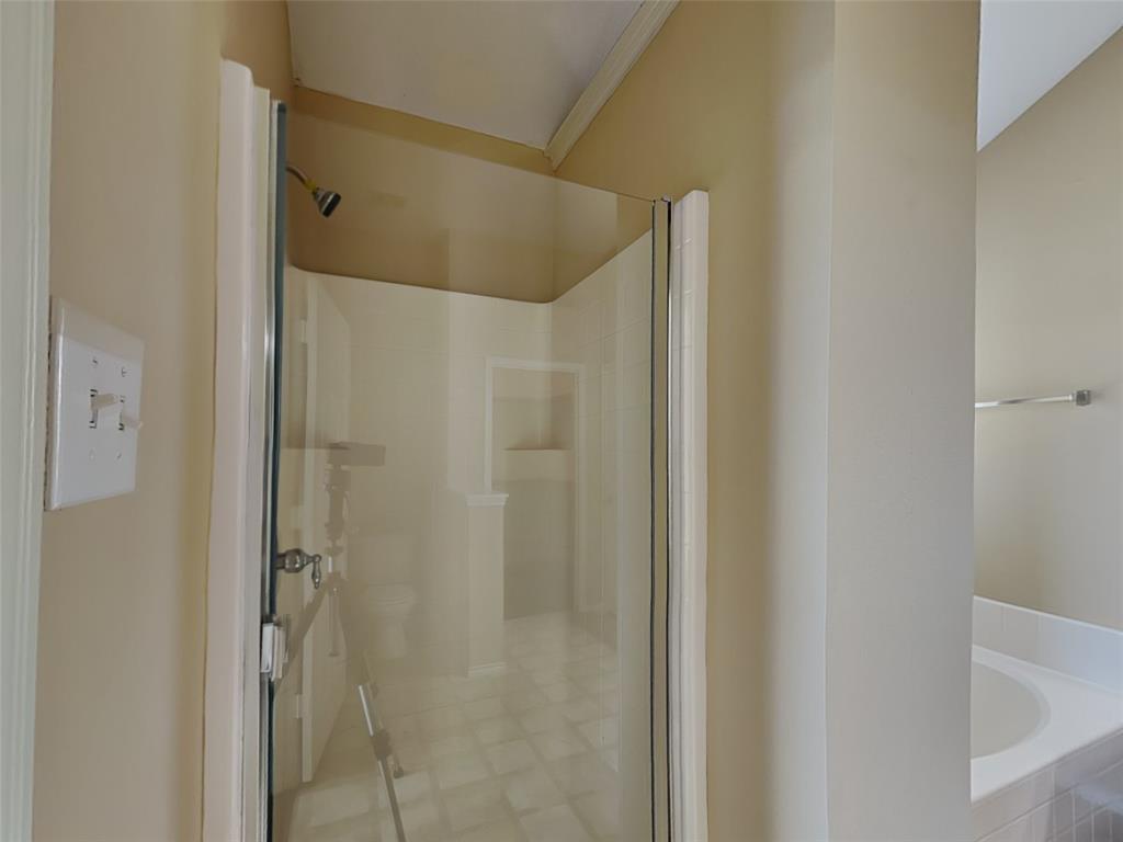 645 Chalk Knoll Road Fort Worth, TX 76108 - Photo 10 of 17 a bathroom with a shower and a glass door