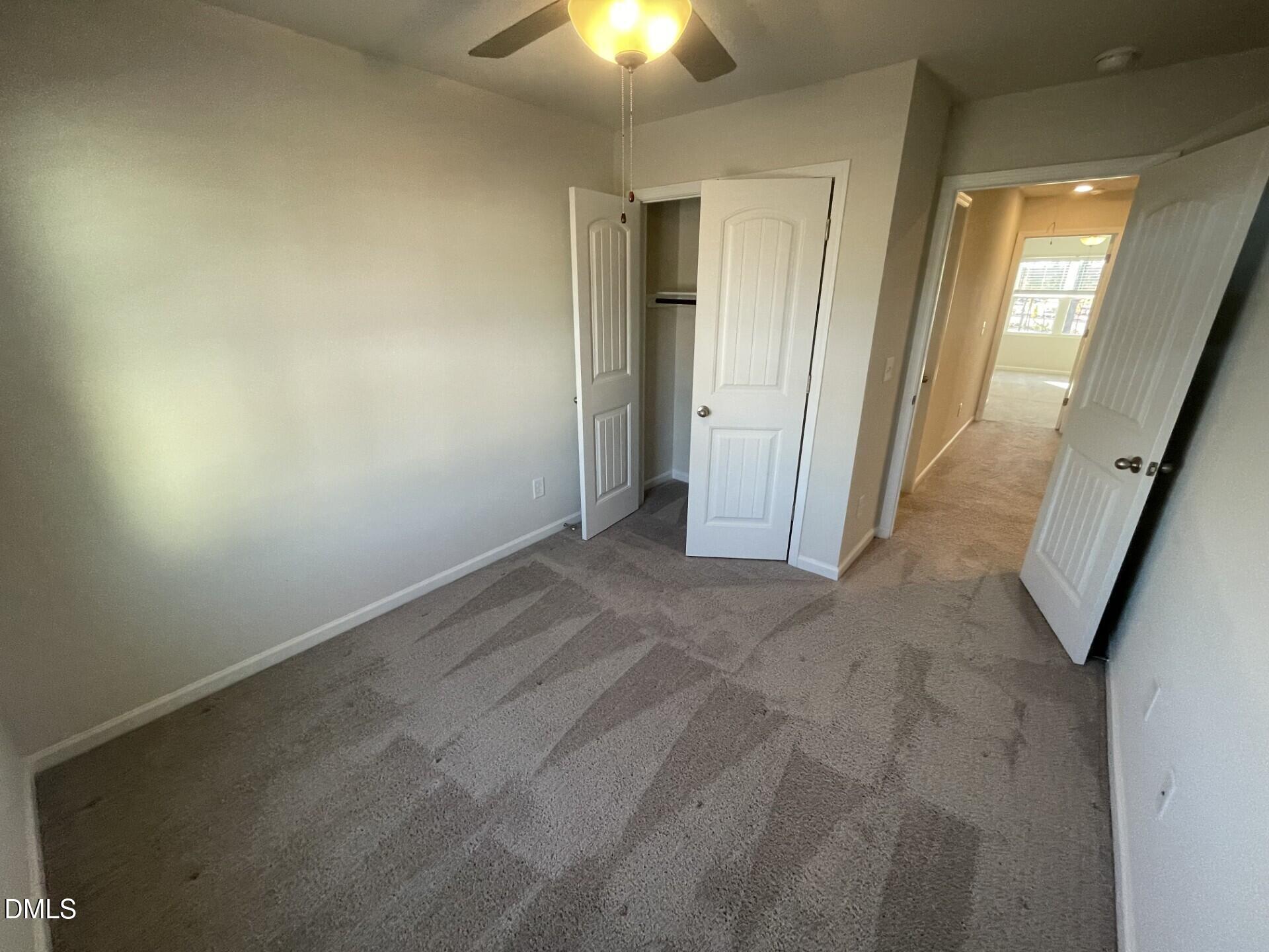 1097 Peony Lane Youngsville, NC 27596 - Photo 12 of 15 an empty room with a ceiling fan and window