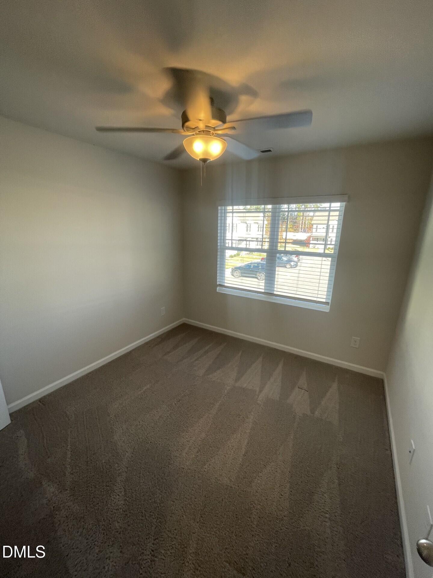 1097 Peony Lane Youngsville, NC 27596 - Photo 13 of 15 an empty room with windows and fan