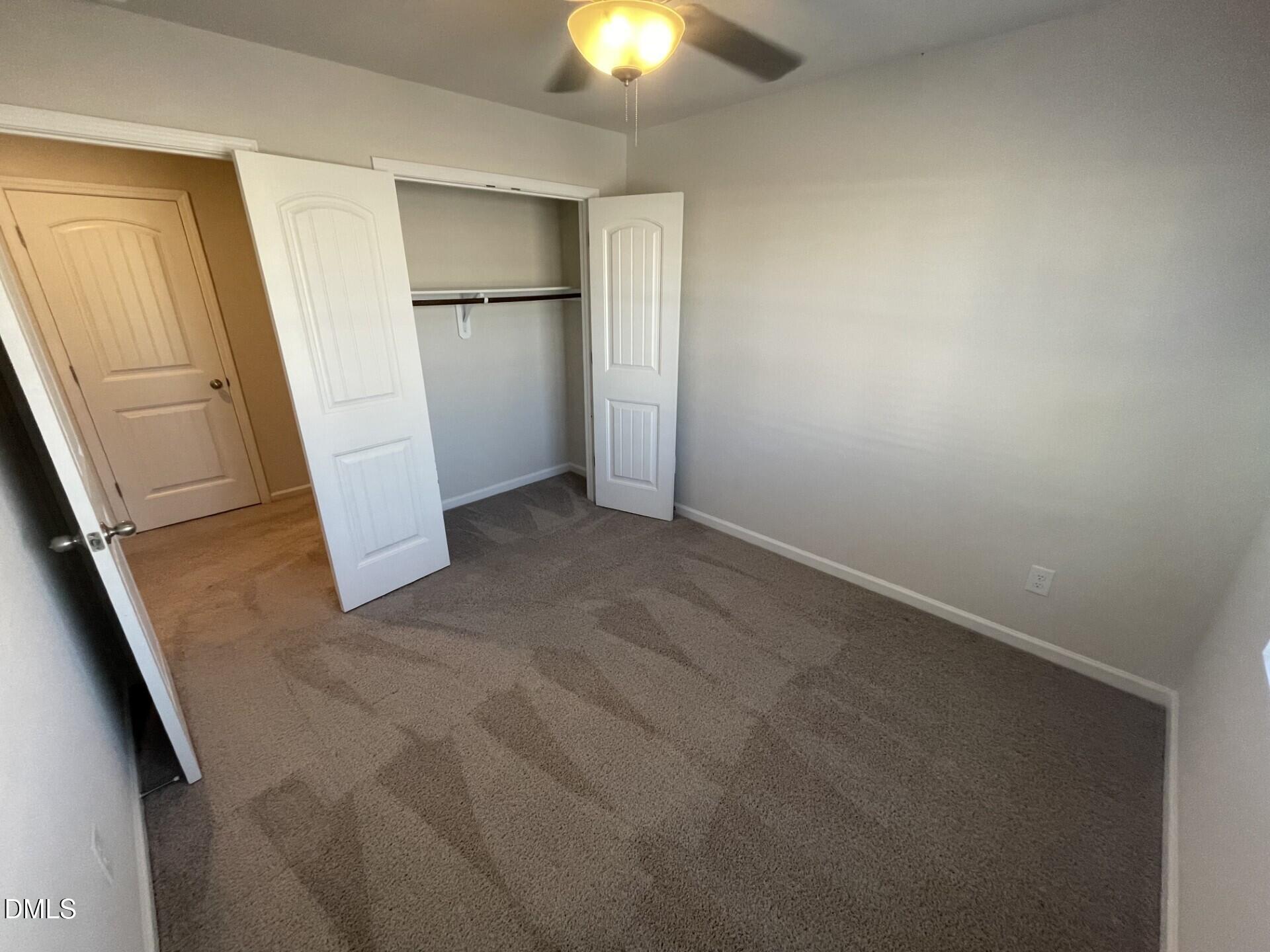 1097 Peony Lane Youngsville, NC 27596 - Photo 14 of 15 an empty room with closet and windows
