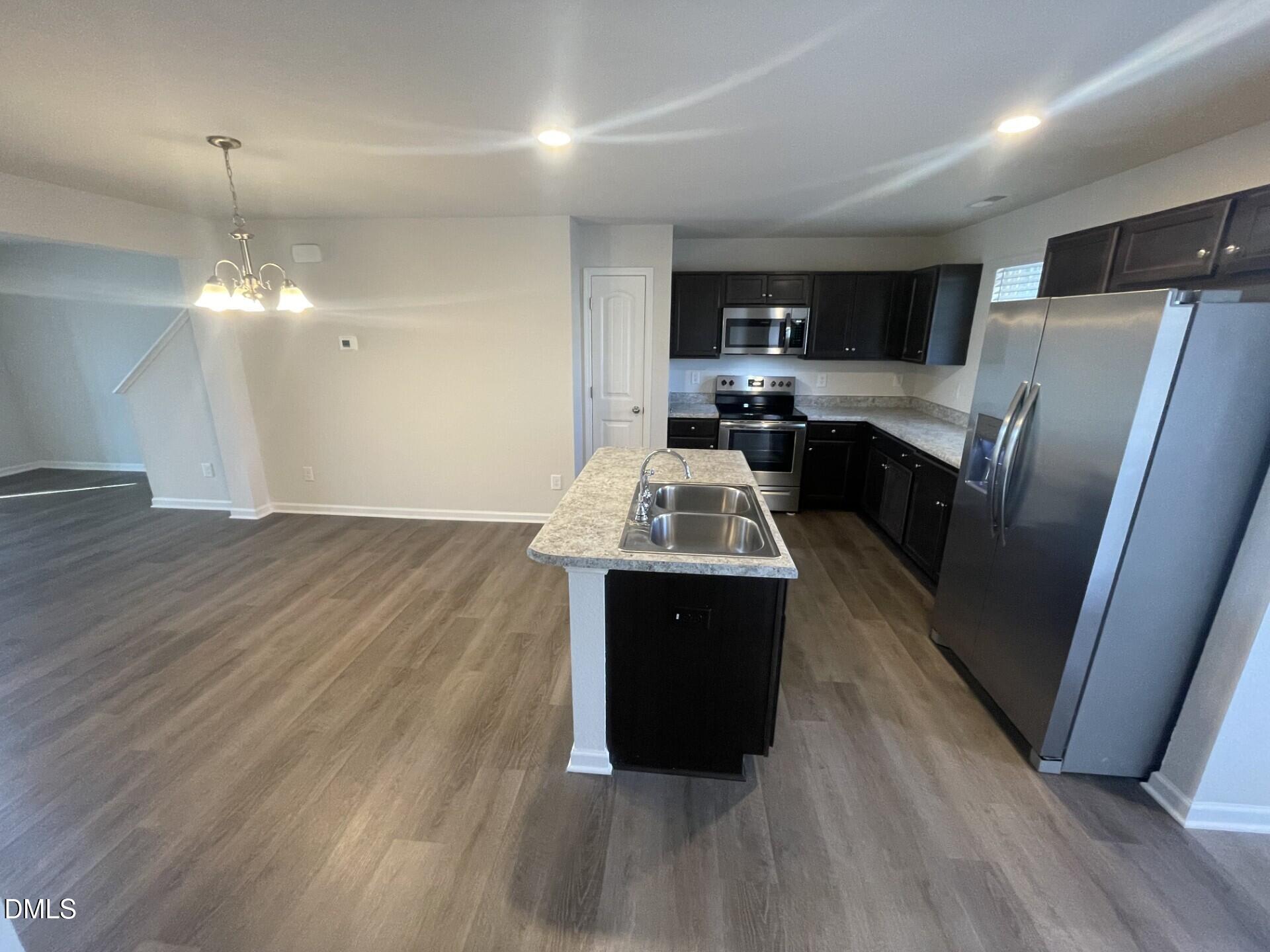 1097 Peony Lane Youngsville, NC 27596 - Photo 3 of 15 a kitchen with a refrigerator and a sink