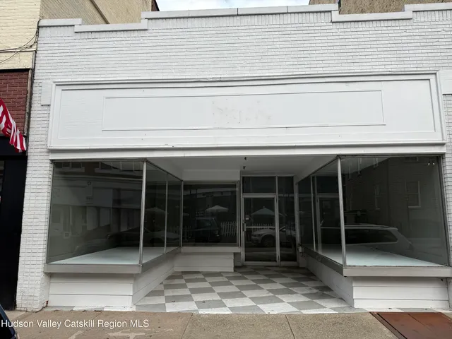 a view of a house with a large window and wooden floor
