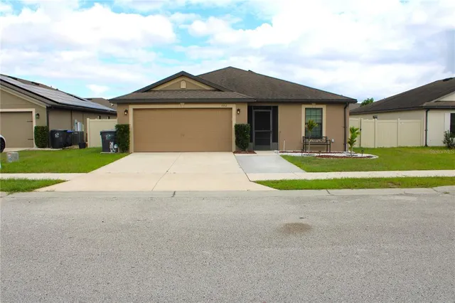 a front view of a house with a yard and garage