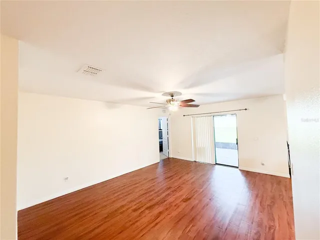 a view of a room with wooden floor