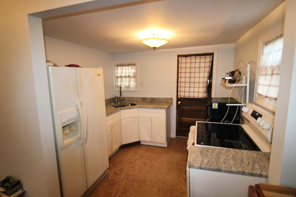 340 Lake Avenue Worcester, MA 01604 - Photo 18 of 37 a kitchen with a refrigerator sink and white cabinets